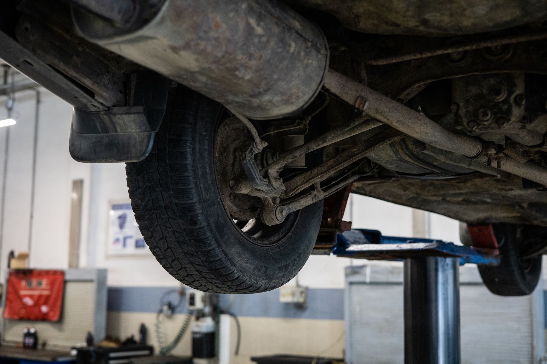 Car undercarriage on a lift during alignment and suspension service
