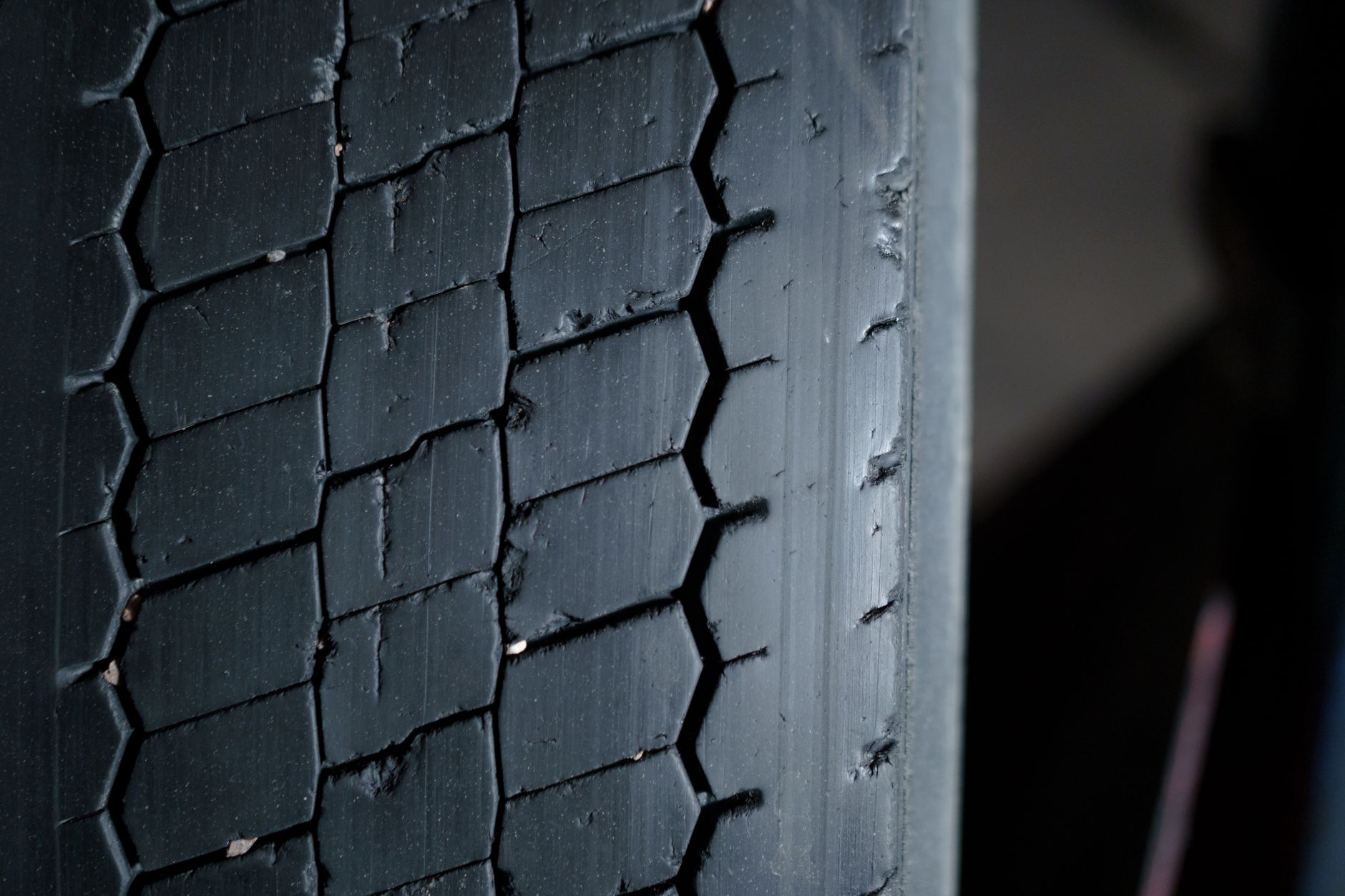 Close-up of a worn tire tread showing grooves and wear pattern