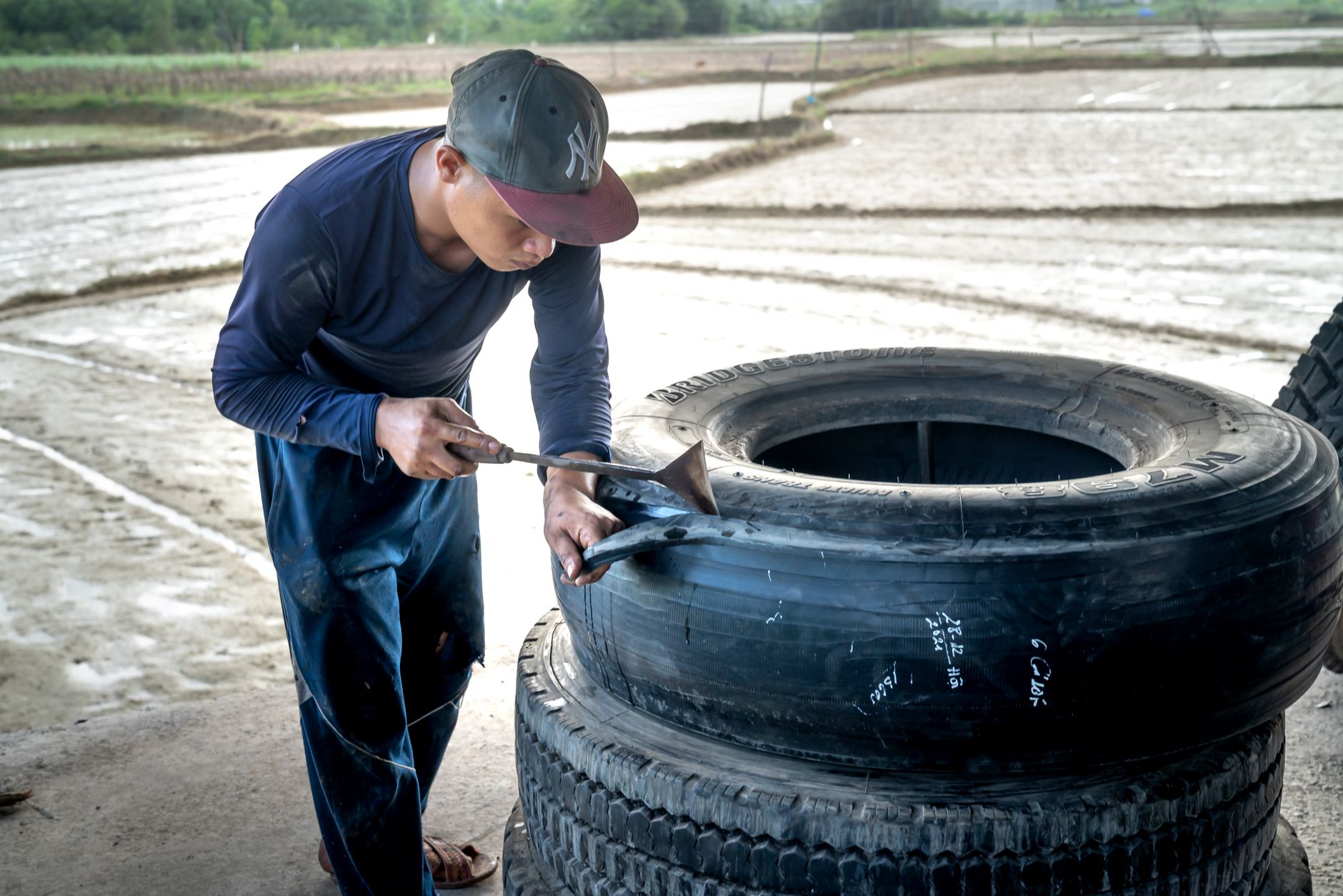 Man working on a tire repair outdoors