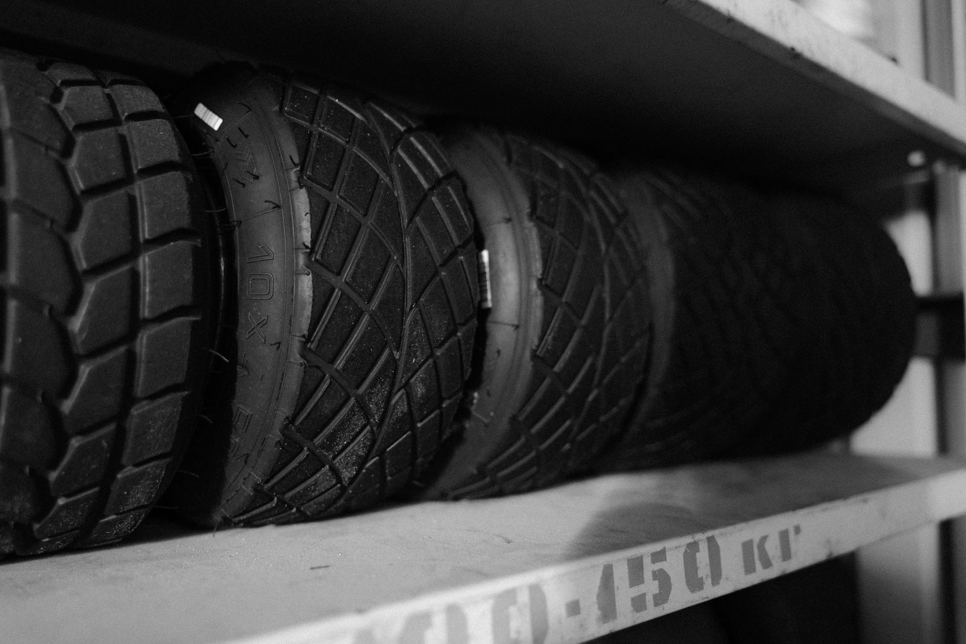 Tires arranged neatly on a shelf in a tire shop